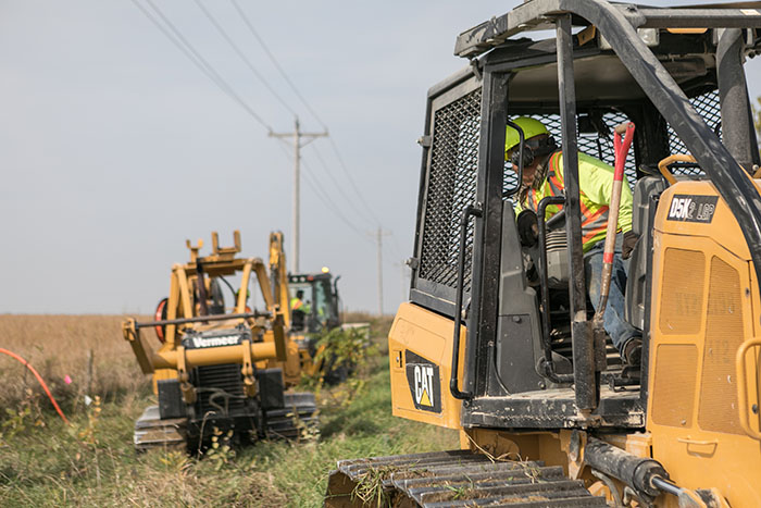 central cable workers laying cable in the country