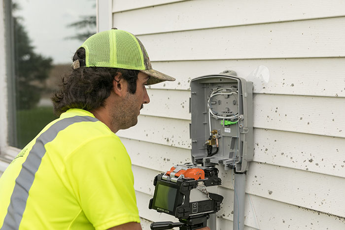 central cable worker installing a cable box