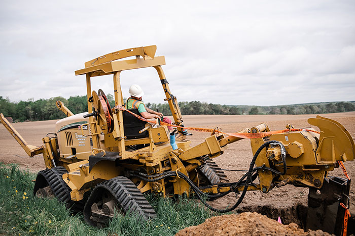 central cable workers laying cable in the country