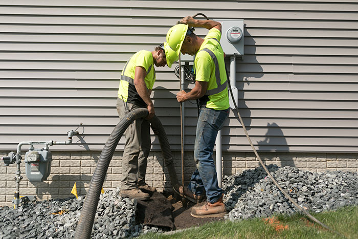 central cable worker placing cables at a home