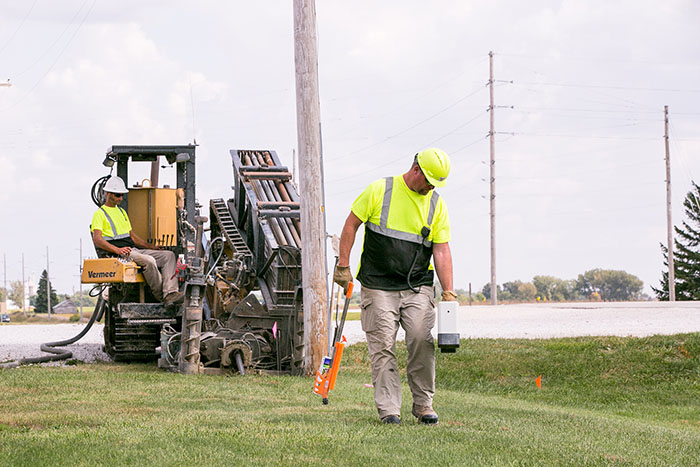 central cable workers laying cable in the country