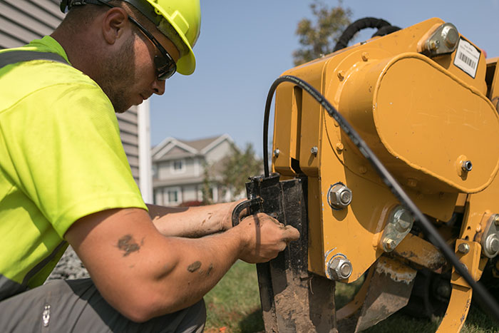 central cable worker placing cables at a home