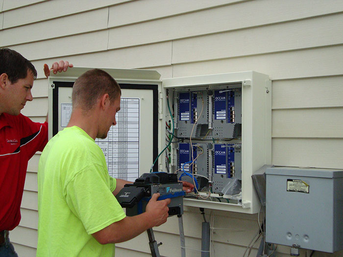 central cable worker installing a cable box