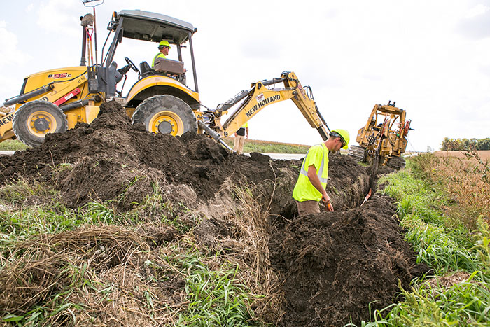 central cable workers laying cable in the country