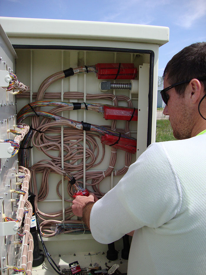 central cable worker organizes wires in a unit