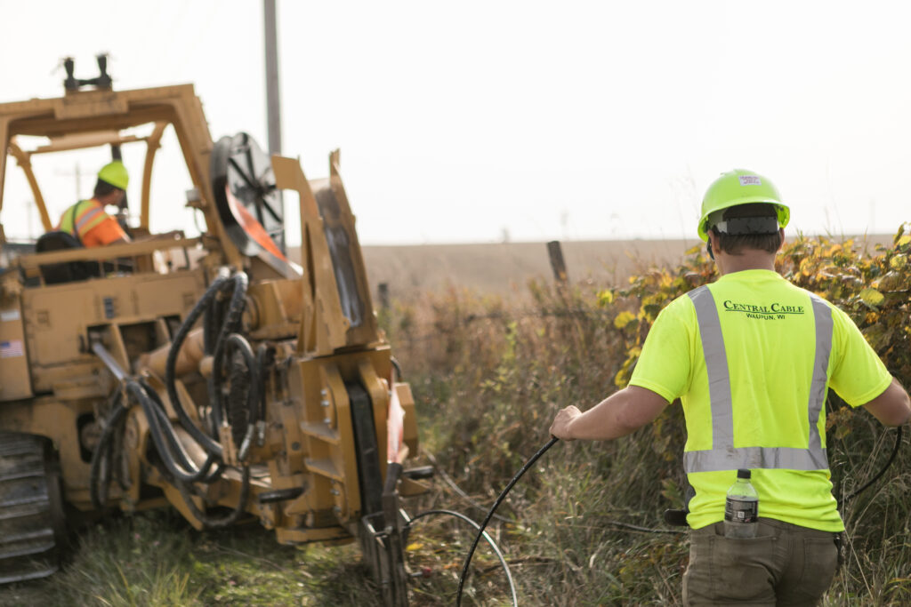 central cable worker laying cables in the country