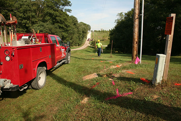 central cable worker marking paint in the grass