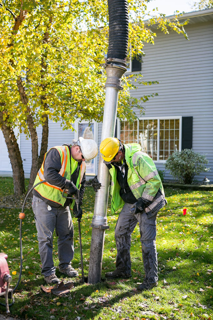 central cable workers placing wires at a home