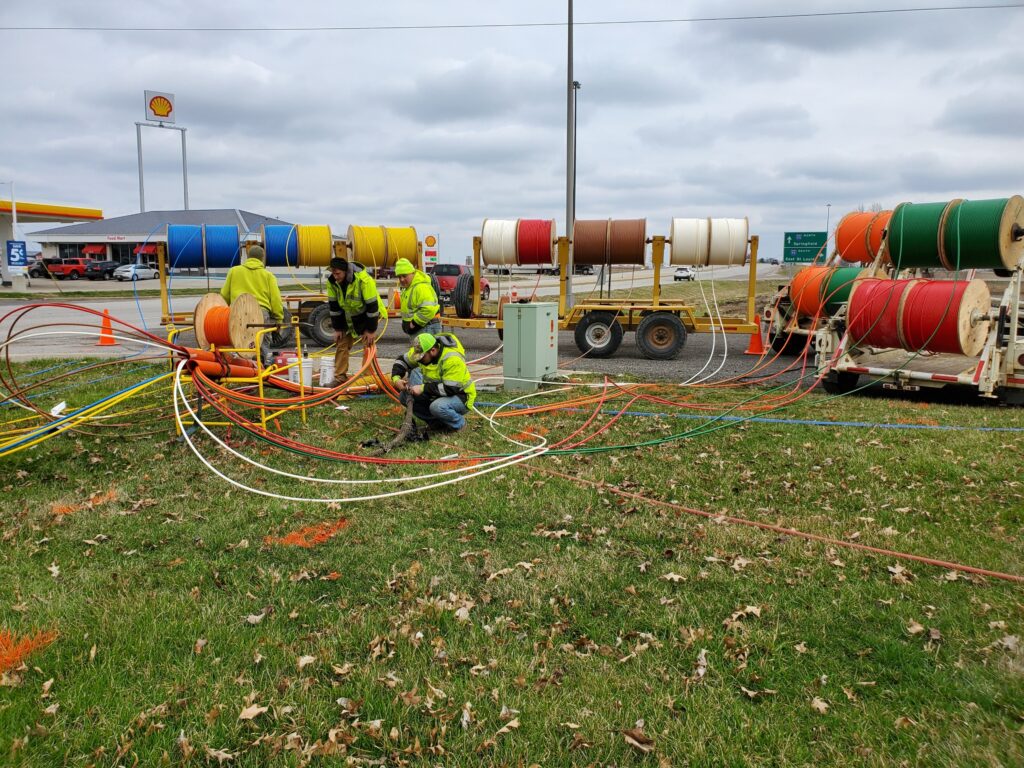 central cable workers putting wires into a cable tube