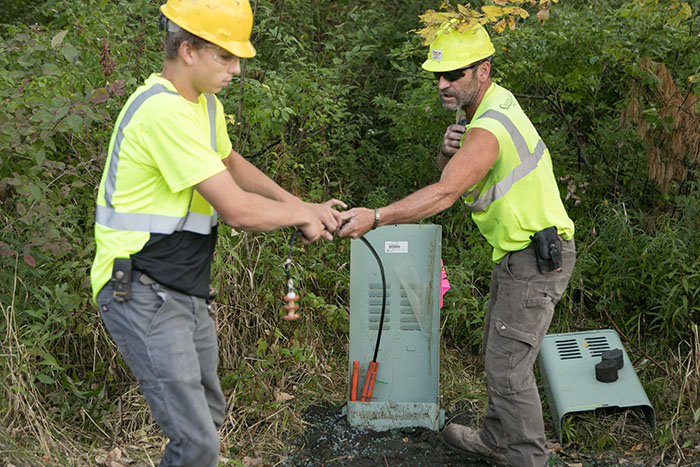 central cable workers working on a cable box