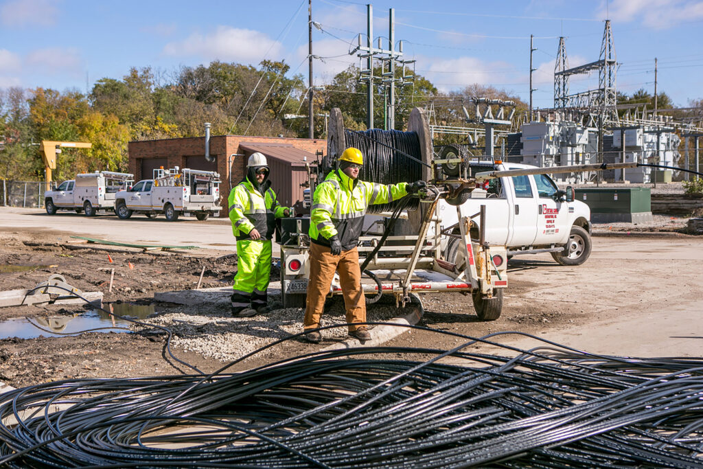 central cable workers laying wires in the fall