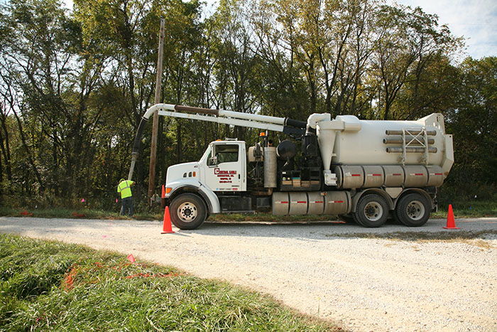 central cable worker putting wire underground