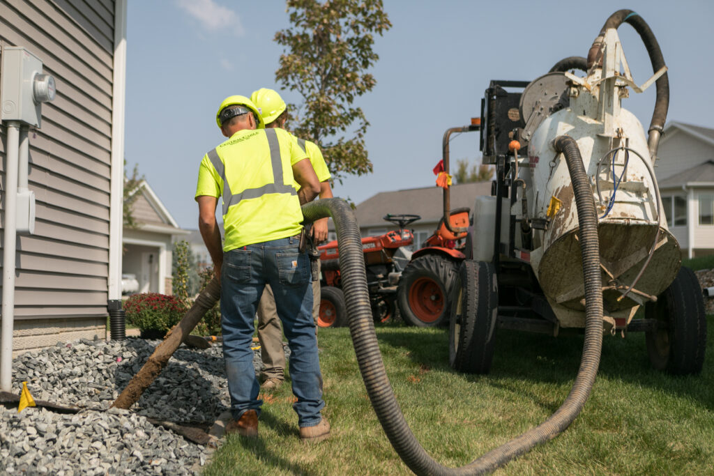 central cable workers placing wires at a home