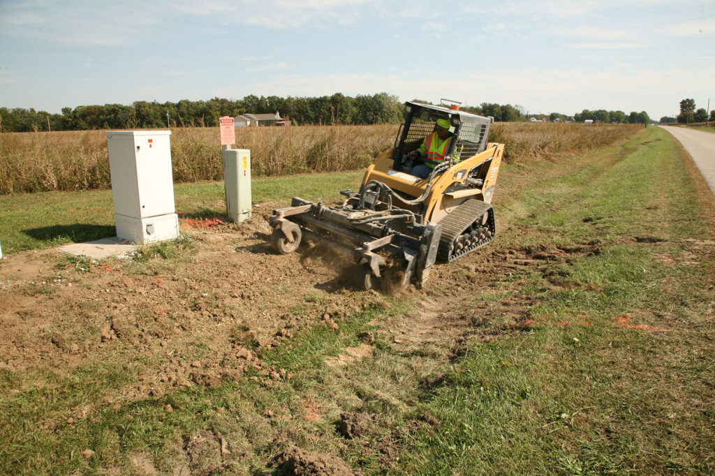 central cable using a cat machine to level dirt