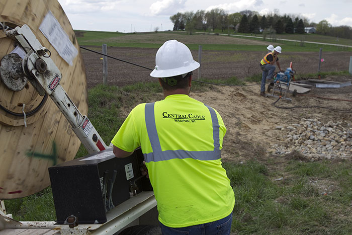 central cable workers looking at a work site