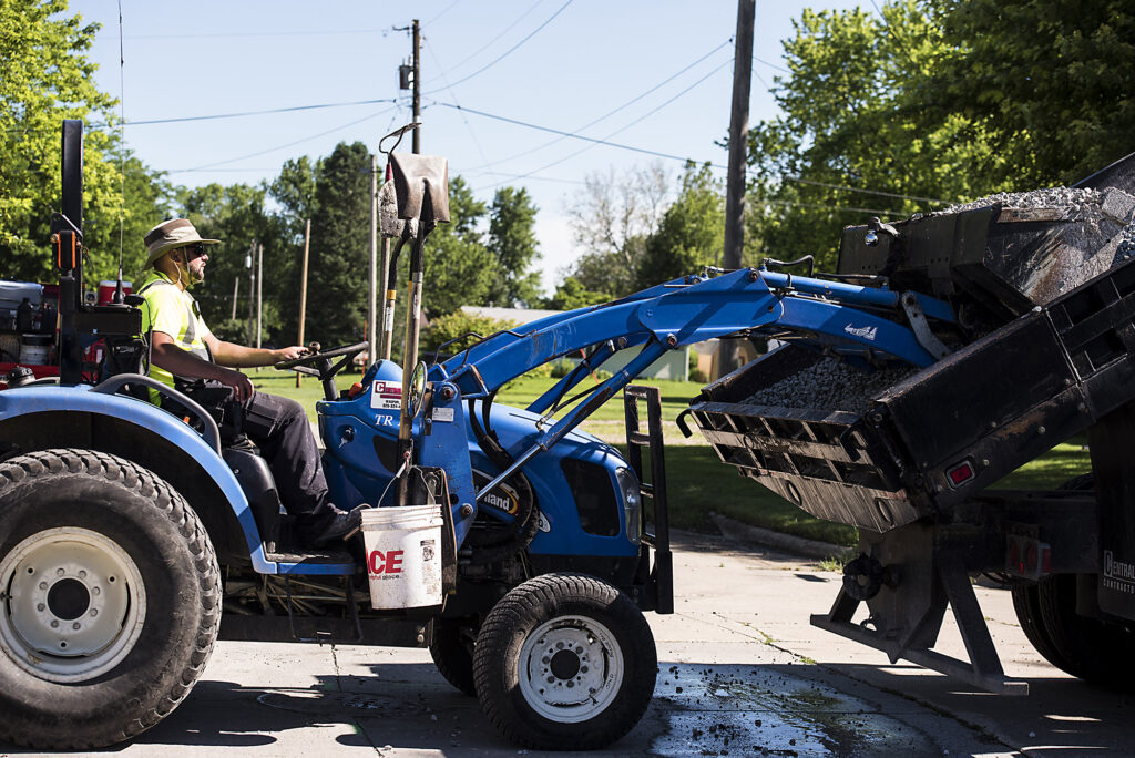 Central Cable workers getting gravel out of a dumb truck