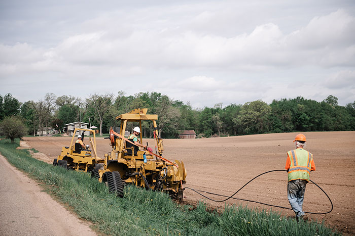 central cable worker laying cables in the country