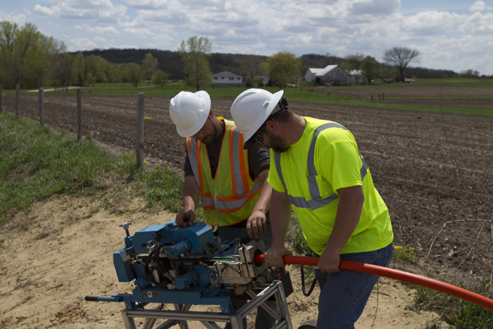 central cable workers cutting tubing