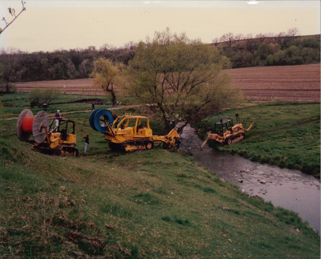 old photo of central cable workers laying cable under water