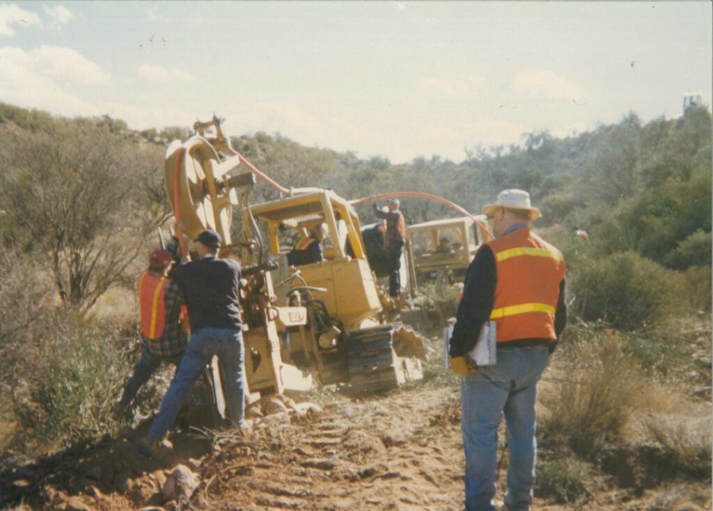 old photo of central cable employees trying to lay cable in the ground