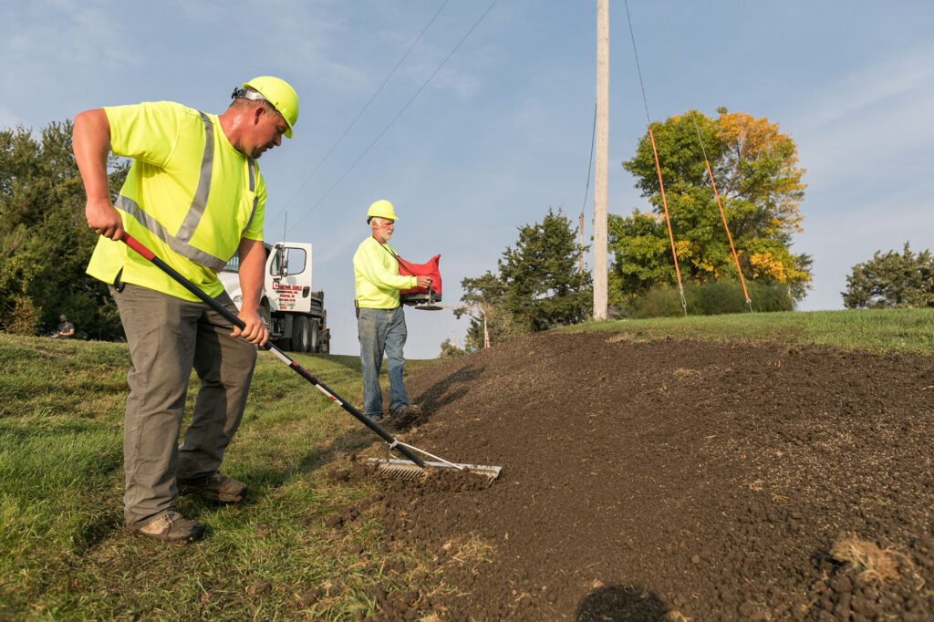 central cables laying grass seed after a project is complete